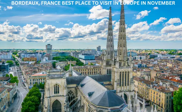 Bordeaux, France in November – A scenic view of Bordeaux's autumn-colored vineyards with historic architecture in the background